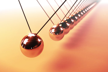 Newton's cradle, action and reaction concept, series of swinging spheres, device that demonstrates conservation of momentum and energy