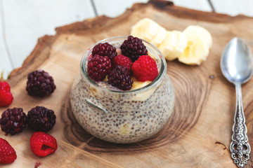 Healthy vanilla chia pudding in a glass with fresh berrie