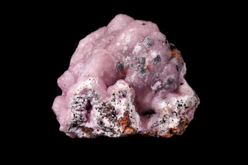 Macro pink Smithsonite mineral stone on microcline on black background