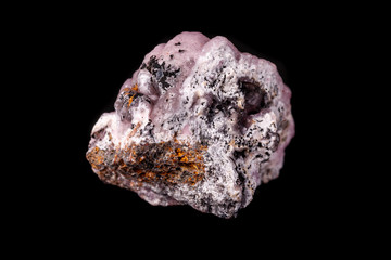 Macro pink Smithsonite mineral stone on microcline on black background