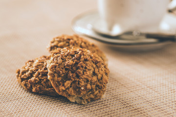 oatmeal cookies on the table and cup of coffe on the background
