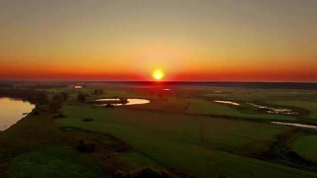 aerial view of river at sunrise 4K, fly over morning mist on the river, Very high view of the river at sunrise, Aerial view of mystical river at sunrise with fog, sun above the river aerial
