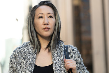 Asian woman in city serious face portrait