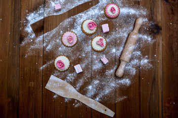 Handmade homemade cookies, rolling pin and flour on a wooden background - top view. Cooking sweets.
