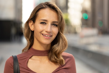 Young woman in city smile happy face portrait