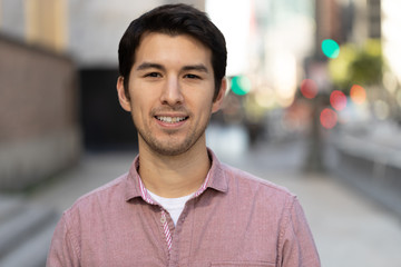 Young man in city smile happy face portrait