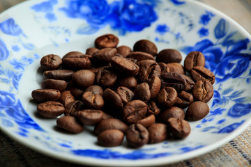 coffee on a plate with blue roses macro