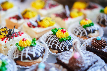 Assortment of pieces of cake on table, copy space. Several slices of delicious desserts, restaurant menu concept