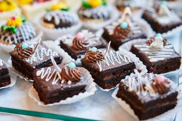 Assortment of pieces of cake on table, copy space. Several slices of delicious desserts, restaurant menu concept