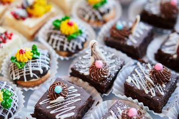 Assortment of pieces of cake on table, copy space. Several slices of delicious desserts, restaurant menu concept