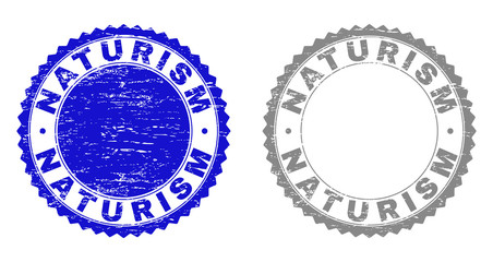 Grunge NATURISM watermarks isolated on a white background. Rosette seals with grunge texture in blue and gray colors. Vector rubber stamp imprint of NATURISM tag inside round rosette.