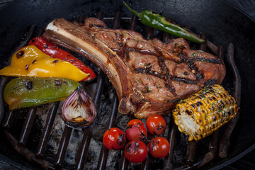  juicy, fried, tender steak with vegetables and sauces on a special stand