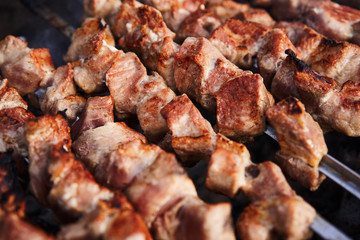 Grilling marinated shashlik on a grill. Shashlik is a form of Shish kebab popular in Europe and other places