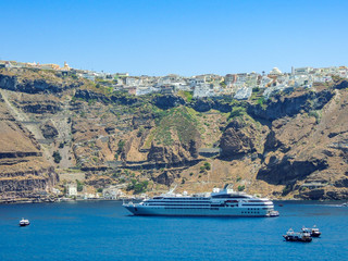 Cruise Ship docked in green harbor.
