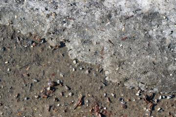 Melting snow asphalt stone grit slush road