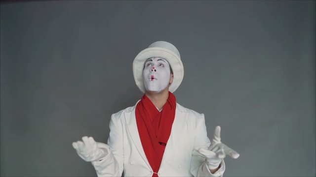 Mime juggles invisible items. Circus fashion pantomime juggles.