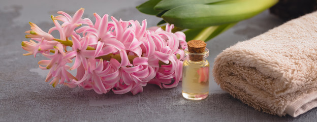 Spa body care concept with a cotton towel and a fresh hyacinth, oil, banner
