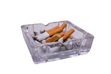 Glass ashtray with cigarettes on a white isolated background