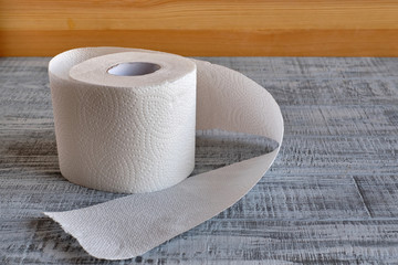 roll of toilet paper on a wooden background