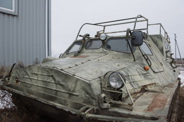 All-terrain vehicle on a caterpillar stands on the ground