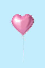 Obraz na płótnie Canvas Pink heart shaped balloon on bright background. Minimal love concept.