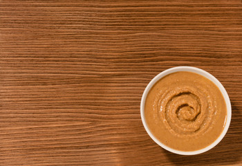 bowl with hot on brown wooden background