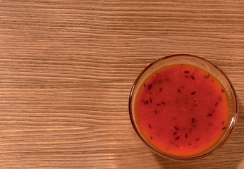 bowl of sea buckthorn jam on brown wooden background