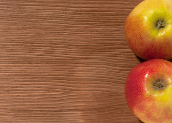 apples on brown wooden background