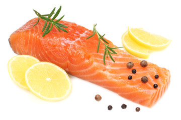 Red fish. Raw salmon fillet with rosemary and lemon isolate on white background.