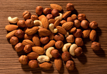 nuts loose on brown wooden background