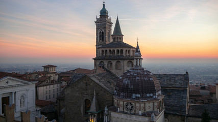 Obraz premium Bergamo, Italy. The old town. Aerial view of the Basilica of Santa Maria Maggiore during the sunset. In the background the Po plain