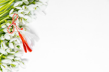 snowdrops flowers arranged on white background with copy space and first of march romanian...