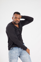 Fototapeta premium Thoughtful Black man in a black shirt and jeans