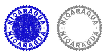 Grunge NICARAGUA stamp seals isolated on a white background. Rosette seals with grunge texture in blue and grey colors. Vector rubber stamp imitation of NICARAGUA title inside round rosette.