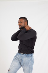 Thoughtful Black man in a black shirt and jeans