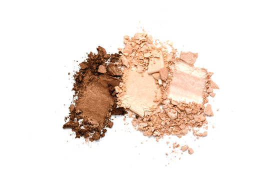 A broken neutral colored eye shadow make up palette isolated on a white background. Top view, flat lay. Copy space for your text