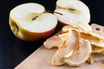 Tasty pieces of dried apples on the kitchen table. Delicious sweet additions to desserts.