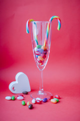 Sweets in a glass on a red background. Valentine's Day