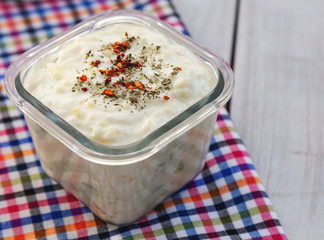 Homemade salad with yogurt, potato and cucumber