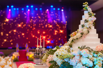 wedding cake  on flower near wedding candle.