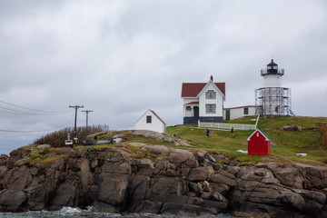 Fototapeta na wymiar York, Maine, United States - October 24, 2018: Nubble Lighthouse being renovated at an off season.