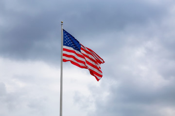 American Flag on the Cloudy background.