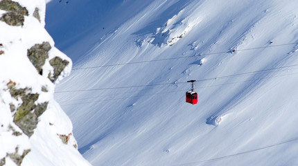 Cable car in winter alpine landscape