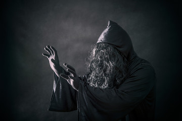 The witch in hooded cloak