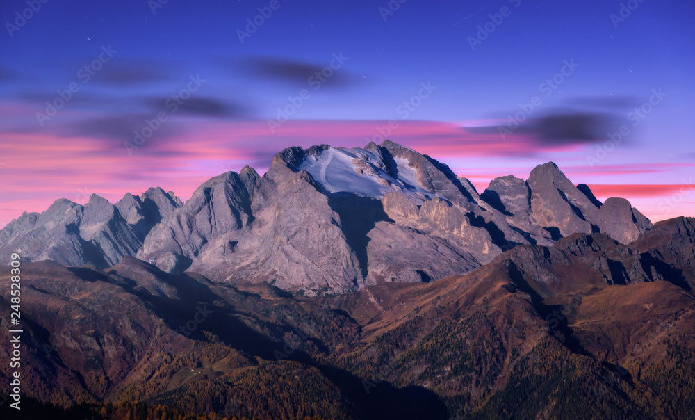 Wall mural mountain peak lighted by moonlight in autumn at night in dolomites, italy. beautiful landscape with 