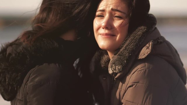 Sad woman crying hugging mother closeup slow motion