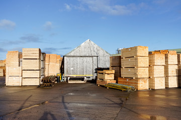 Wood chips pellets chopped wooden logsand stacked wooden pallets for biomass fuel at sawmill