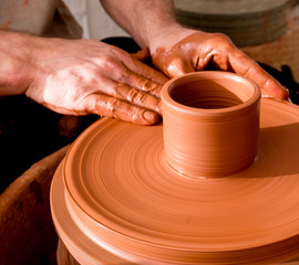 Professional potter making bowl in pottery workshop
