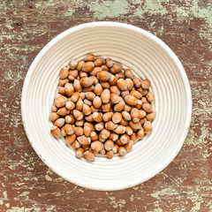 Wicked basket with ripe unpeeled hazelnuts