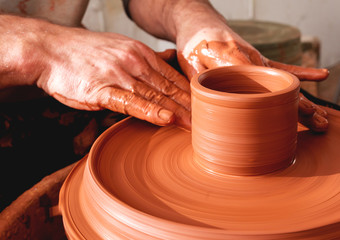 Professional potter making bowl in pottery workshop